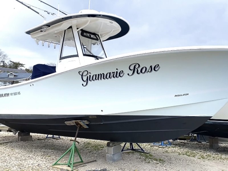 Black script boat lettering reading Giamarie Rose on the white hull of a Regulator center console